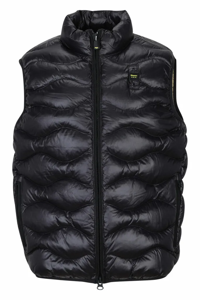 Chaleco negro con líneas onduladas e interior beige