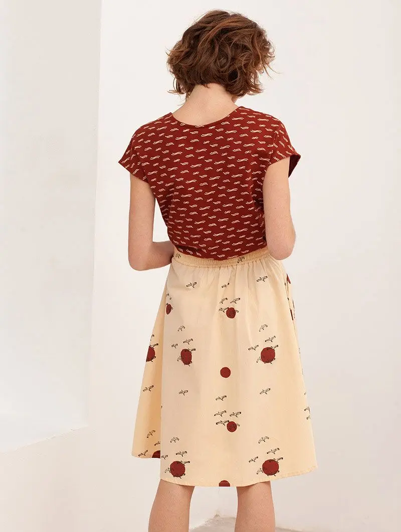 Falda de algodón orgánico beige con pájaros